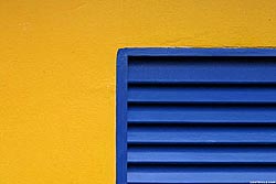Blue Shutter on a Yellow Wall